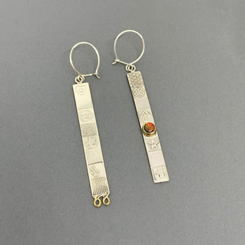 View and buy intricate fine art at The Biscuit Factory, Newcastle-based art gallery. Image shows two slim silver earrings.