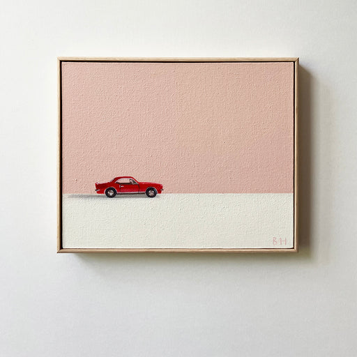 an original painting of a red toy car on a white surface with a pink background behind it