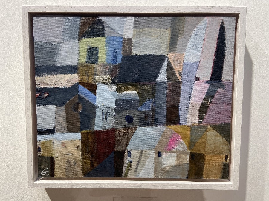 Image shows an abstract painting 'Church with Birds' by artist Michael St Clair for sale at The Biscuit Factory art gallery. The painting is of a village with a church in the centre and two birds flying above, hung on a white wall.