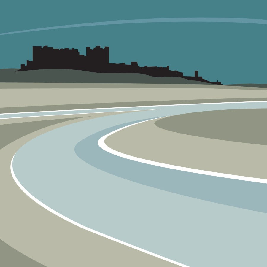 Image shows a giclee art print by Ian Mitchell for sale at The Biscuit Factory, depicting the silhouette of Bamburgh Castle above the beach in shades of blue, grey and black.