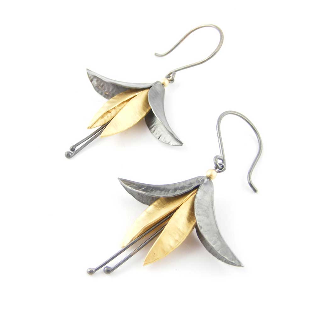 Buy 'Oxidised Silver and Gold Fuchsia Earrings', mixed metal flower earrings by jeweller Nettie Birch. Image shows a a pair of oxidised silver and gold fuchsia flower earrings hanging from oxidised hooks. The earrings sit on a white background.