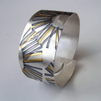 Original handmade jewellery by Jessica Briggs at the Biscuit Factory. Image shows silver ring with intricate gold pattern.
