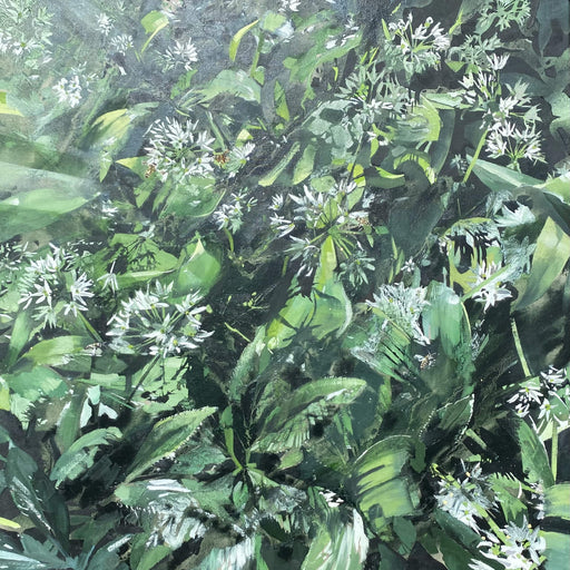 Close-up of green leaves and white flowers in a natural setting