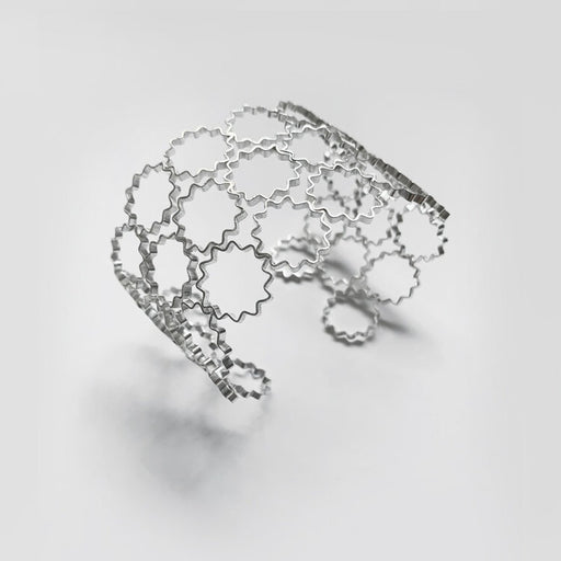 Mini Onduléé Cuff by Olivia Taylor, A silver cuff bracelet of many adjoined silver star shapes. | Contemporary Jewellery for sale at The Bisct Factory Newcastle