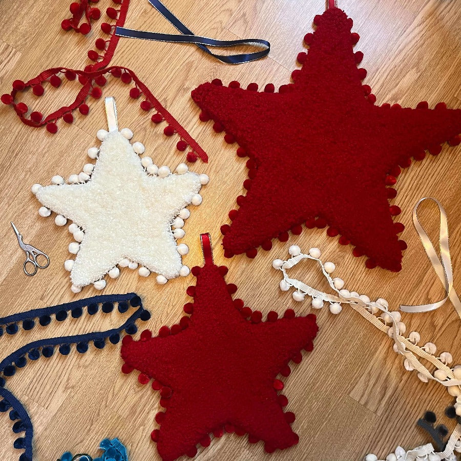 Red and white tufted star Christmas Decorations by Loop and Yarn from their Christmas workshop at The Biscuit Factory Newcastle.