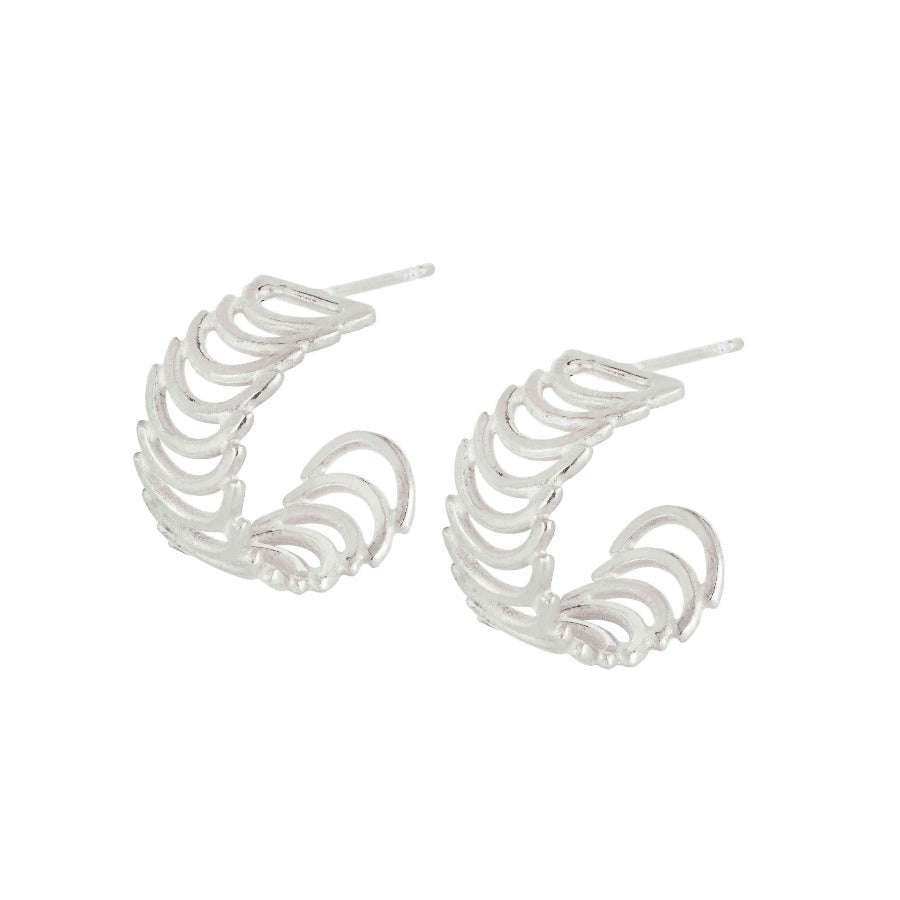 Cadence Hoop Earrings by Cailtin Hegney. A pair of silver earrings of stacked semi circles in a curved shape. | Contemporary jewellery at The Biscuit Factory Gallery