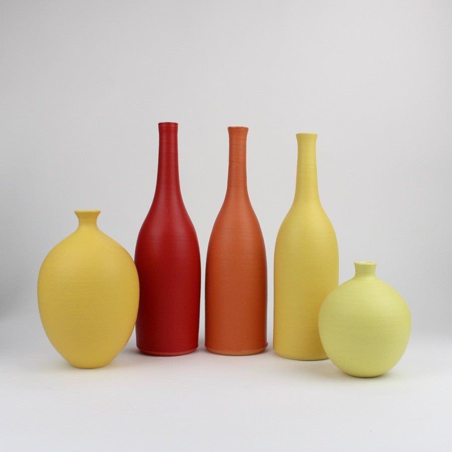 Ceramic pots by Lucy Burley, a selection of different shaped pots in yellow and orange colours. | Contemporary homewares for sale at The Biscuit Factory Newcastle