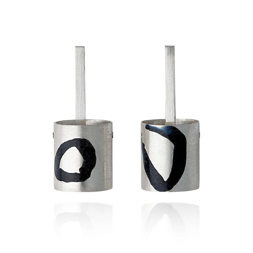 Enamel Inlay Studs by Lyndsay Fairley, a pair of silver cylindrical earrings with black, abstract enamel details. | Find original, handmade jewellery for sale at The Biscuit Factory Newcastle