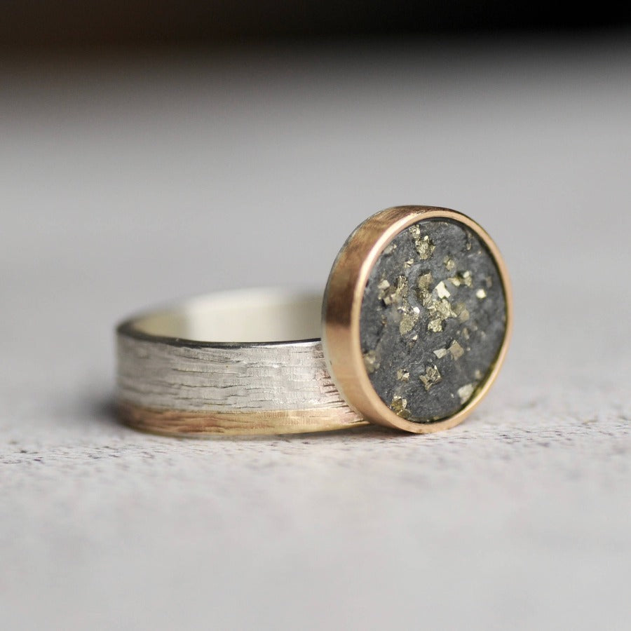 Flux Ring by Rebecca Burt - a round slate with pyrite disc set in gold on a silver and gold band. | Unique handmade jewellery for sale at The Biscuit Factory Newcastle.