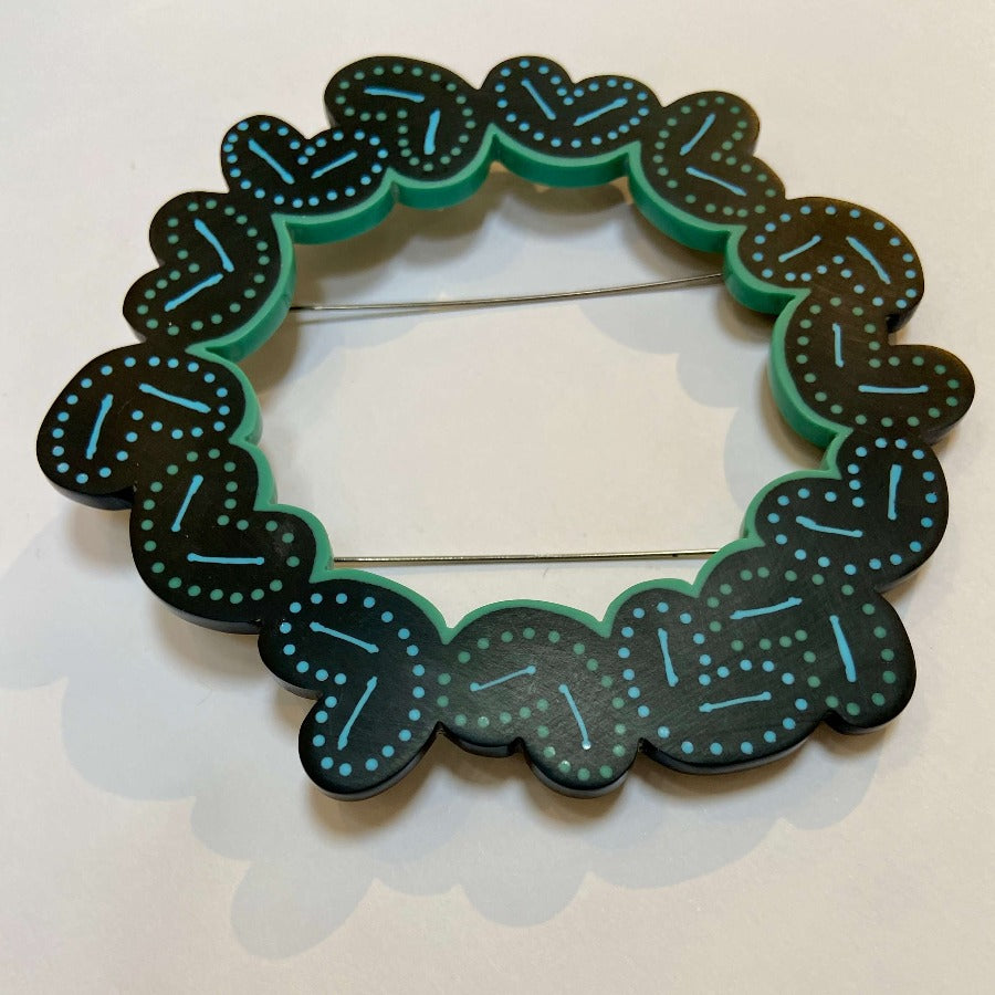 Garland Brooch by Karen McMillan Jewellery, a black, green and turquoise resin brooch. | Colourful handmade jewellery for sale at The Biscuit Factory Newcastle