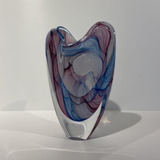 Buy 'Pastel Georgia V Form' glass vase by Peter Layton online at The Biscuit Factory. Image shows a glass vase with a 'V' shape. It has swirls of light blue, pink and white colour beneath the clear surface.