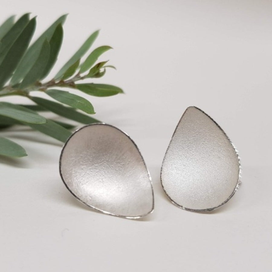 Plain Pyrus Earrings by Donna Barry, a pair of silver petal shaped ear studs.  | Unique jewellery for sale at The Biscuit Factory Newcastle.
