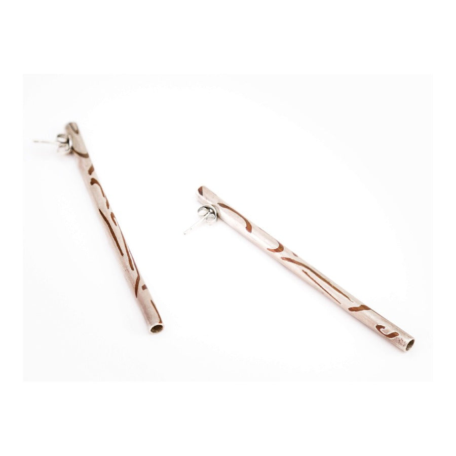 Long silver earrings with copper inlay by Lyndsay Fairley, a pair of long silver tubular earrings with abstract copper pattern. | Original art for sale at The Biscuit Factory Newcastle