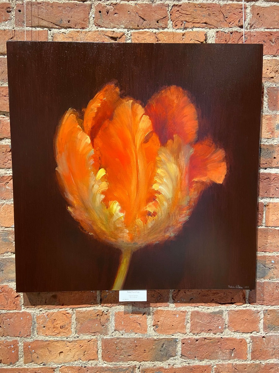 Rasta Parrot Tulip by Fletcher Prentice, an original painting of an orange 'Parrot Tulip' against a black background hung on a brick wall. | Original art for sale at The Biscuit Factory Newcastle