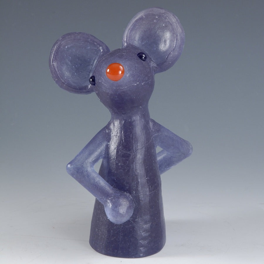 Buy 'Jolly', a handmade glass cast mouse by Morag Reekie. Image shows a glass figurine of a cartoon mouse cut off at the waist, with a purple body and an orange nose. The sculpture sits on a grey background.