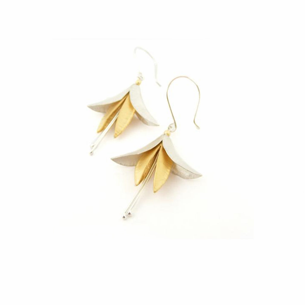 Buy 'Silver and Gold Fuchsia Earrings', mixed metal floral earrings by jeweller Nettie Birch. Image shows silver and gold fuchsia flowers hanging from silver ear hooks laying on a white background.