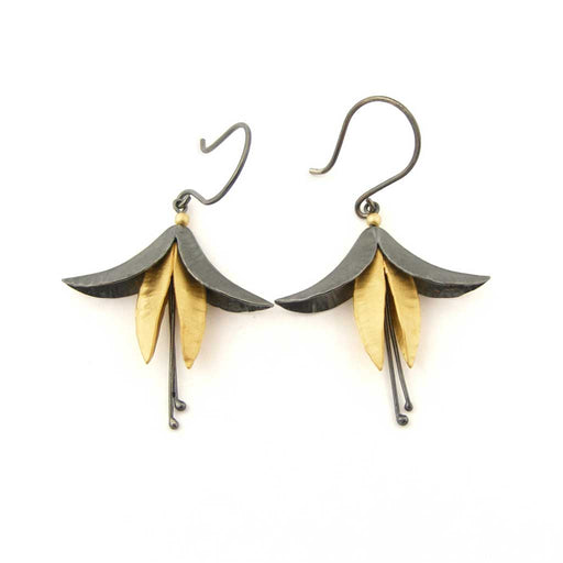 Buy 'Oxidised Silver and Gold Fuchsia Earrings', mixed metal flower earrings by jeweller Nettie Birch. Image shows a a pair of oxidised silver and gold fuchsia flower earrings hanging from oxidised hooks. The earrings sit on a white background.