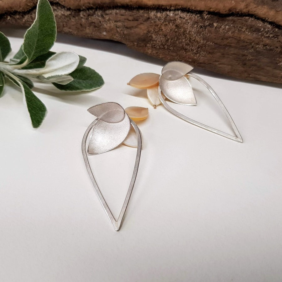 Large Fritillaria Loop Earrings by Donna Barry, a pair of floral inspired silver earrings with petal motifs in silver and pearl. | Unique jewellery for sale at The Biscuit Factory Newcastle.